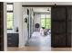 Bright living room featuring large windows, a sliding barn door, and modern decor at 5160 Howard Rd, Cumming, GA 30040