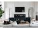 Modern living room features a fireplace, television, comfortable seating, and stylish decor at 5160 Howard Rd, Cumming, GA 30040
