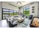 Bright and airy living room with views of the pool and surrounding landscape at 5160 Howard Rd, Cumming, GA 30040