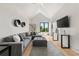 Spacious living room with vaulted ceilings, comfortable seating, and a large wall-mounted television at 5160 Howard Rd, Cumming, GA 30040