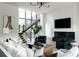 Bright living room with a modern staircase, fireplace, comfortable seating, and stylish decor at 5160 Howard Rd, Cumming, GA 30040