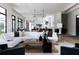 Modern living area featuring white sectional sofa, wooden coffee table, and chic accents at 5160 Howard Rd, Cumming, GA 30040