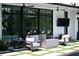 Comfortable outdoor seating area with a modern fireplace and ceiling fans offering a view to lush greenery at 5160 Howard Rd, Cumming, GA 30040
