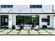 Outdoor seating and grill area with a covered patio and ceiling fans overlooks a modern rectangular pool at 5160 Howard Rd, Cumming, GA 30040