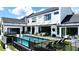 Rear aerial view of home features a modern pool, patio seating, and turfstone and outdoor grill area at 5160 Howard Rd, Cumming, GA 30040