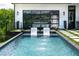Stunning pool with water feature, set within a beautifully landscaped outdoor area, with seamless indoor-outdoor living at 5160 Howard Rd, Cumming, GA 30040