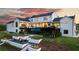 The rear exterior showcases a modern farmhouse design, featuring a unique cantilevered pool and manicured outdoor living space at 5160 Howard Rd, Cumming, GA 30040