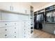 Bright walk-in closet with custom shelving and drawers for optimal storage of clothing, shoes, and accessories at 5160 Howard Rd, Cumming, GA 30040