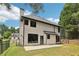 Home's back exterior with a fenced yard, patio, and black window trim at 1045 River Valley Dr, Dacula, GA 30019