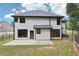 Home's back exterior features a patio, fenced yard, and modern black trim at 1045 River Valley Dr, Dacula, GA 30019
