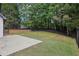 Spacious backyard with mature trees and a patio area at 1045 River Valley Dr, Dacula, GA 30019