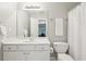 A clean, all white bathroom featuring modern fixtures, and natural light at 1045 River Valley Dr, Dacula, GA 30019