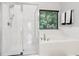 This bathroom features tile floors, a soaking tub, and a glass shower at 1045 River Valley Dr, Dacula, GA 30019
