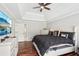 This bedroom offers a ceiling fan, hardwood floors, and a flat screen tv at 1045 River Valley Dr, Dacula, GA 30019