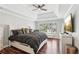 This bedroom has a ceiling fan, hardwood floors, and large window at 1045 River Valley Dr, Dacula, GA 30019