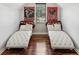 Bonus room featuring twin daybeds, hardwood floors, and natural light at 1045 River Valley Dr, Dacula, GA 30019