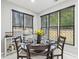 Bright breakfast nook with three windows and a round table set for four at 1045 River Valley Dr, Dacula, GA 30019