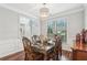 Formal dining room with hardwood floors, modern lighting, and staircase access at 1045 River Valley Dr, Dacula, GA 30019