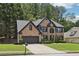 Charming two-story brick home featuring a well-manicured lawn and attached two-car garage at 1045 River Valley Dr, Dacula, GA 30019