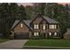 Charming two-story brick home featuring a well-manicured lawn and attached two-car garage at 1045 River Valley Dr, Dacula, GA 30019