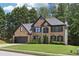 Charming two-story brick home featuring a well-manicured lawn and attached two-car garage at 1045 River Valley Dr, Dacula, GA 30019