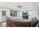 A comfortable living room featuring wood floors, a fireplace and large windows at 1045 River Valley Dr, Dacula, GA 30019