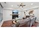A comfortable living room featuring wood floors, a fireplace and large windows at 1045 River Valley Dr, Dacula, GA 30019