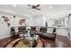Spacious open-concept living area with a sectional sofa, fireplace, and modern decor at 1045 River Valley Dr, Dacula, GA 30019