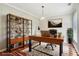 Home office featuring a large desk, shelving, and natural light, ideal for productivity at 1045 River Valley Dr, Dacula, GA 30019