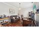 Comfortable home office with dark wood floors, leather furniture, and a mounted TV at 1045 River Valley Dr, Dacula, GA 30019