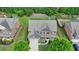 Aerial view of a two-story home with a well-manicured lawn and mature trees surrounding the property at 1370 Sunnys Halo Dr, Suwanee, GA 30024