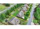 Aerial view of a two-story home with a green lawn and a driveway in a lush, green suburban neighborhood at 1370 Sunnys Halo Dr, Suwanee, GA 30024