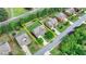 Aerial view of a two-story home with a lawn and driveway in a suburban neighborhood surrounded by green trees at 1370 Sunnys Halo Dr, Suwanee, GA 30024