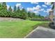Large, grassy backyard with mature trees and partial fence. Ready for entertaining at 1370 Sunnys Halo Dr, Suwanee, GA 30024