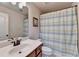 Bathroom featuring a single sink vanity, toilet, and shower/tub combo with striped curtain at 1370 Sunnys Halo Dr, Suwanee, GA 30024