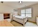 Comfortable bedroom offering a window for natural light and neutral-colored walls at 1370 Sunnys Halo Dr, Suwanee, GA 30024
