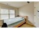 Simple bedroom featuring a twin bed, window, and wall decor at 1370 Sunnys Halo Dr, Suwanee, GA 30024