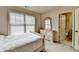 Bright bedroom featuring neutral-colored walls and a window for natural light at 1370 Sunnys Halo Dr, Suwanee, GA 30024