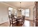 Formal dining room featuring hardwood floors, crown molding, and ample natural light at 1370 Sunnys Halo Dr, Suwanee, GA 30024