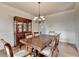 Traditional dining room with hardwood floors, chandelier, and a large china cabinet at 1370 Sunnys Halo Dr, Suwanee, GA 30024
