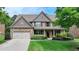 Charming two-story brick home with well-manicured lawn and landscaping at 1370 Sunnys Halo Dr, Suwanee, GA 30024