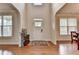 Bright foyer with hardwood floors and view to dining room at 1370 Sunnys Halo Dr, Suwanee, GA 30024