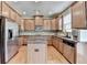 Well-appointed kitchen featuring stainless steel appliances, granite counters, and a center island at 1370 Sunnys Halo Dr, Suwanee, GA 30024