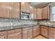 Close-up of a kitchen with stainless steel microwave and gas stovetop at 1370 Sunnys Halo Dr, Suwanee, GA 30024