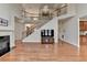 Elegant living room showcasing a fireplace, hardwood floors, and staircase at 1370 Sunnys Halo Dr, Suwanee, GA 30024