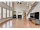 Spacious living room with hardwood floors, large windows, fireplace, and open staircase at 1370 Sunnys Halo Dr, Suwanee, GA 30024