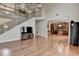 Bright living room featuring a staircase and an open view into the kitchen at 1370 Sunnys Halo Dr, Suwanee, GA 30024
