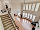 Grand living room showcasing soaring ceilings, large windows, hardwood floors, and an elegant fireplace at 1370 Sunnys Halo Dr, Suwanee, GA 30024
