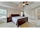 Spacious main bedroom featuring a tray ceiling, ceiling fan, and carpeted floors at 1370 Sunnys Halo Dr, Suwanee, GA 30024
