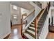 Grand foyer with a staircase featuring wrought iron spindles and wood railing at 1370 Sunnys Halo Dr, Suwanee, GA 30024